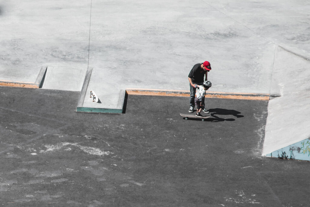 Skate with Jack, skateboarding instructor teaching a child to skateboard